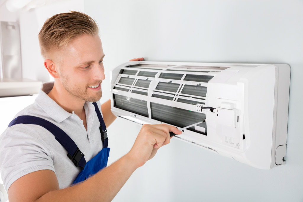 HVAC technician performing ductless air conditioning maintenance in Eagle Mountain