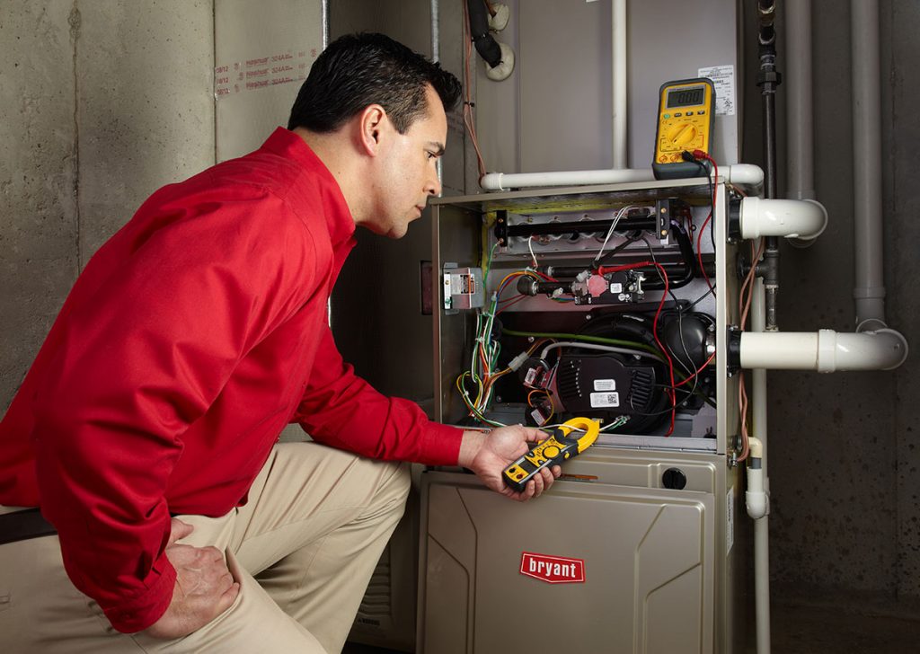 HVAC technician repairing an indoor furnace in Eagle Mountain