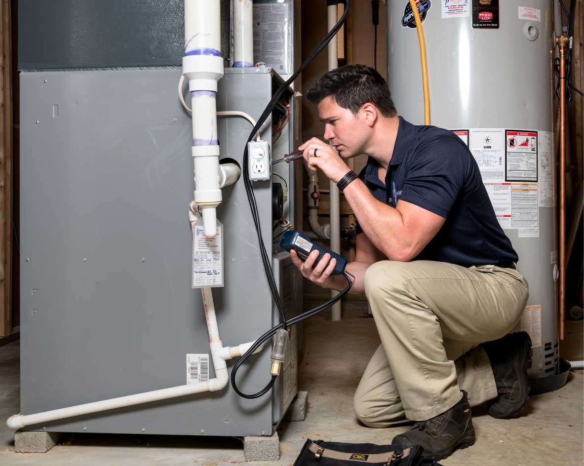 HVAC technician performing a furnace tune-up in Eagle Mountain