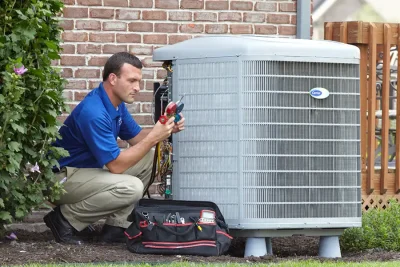 HVAC technician inspecting an outdoor air conditioning unit in Eagle Mountain, UT
